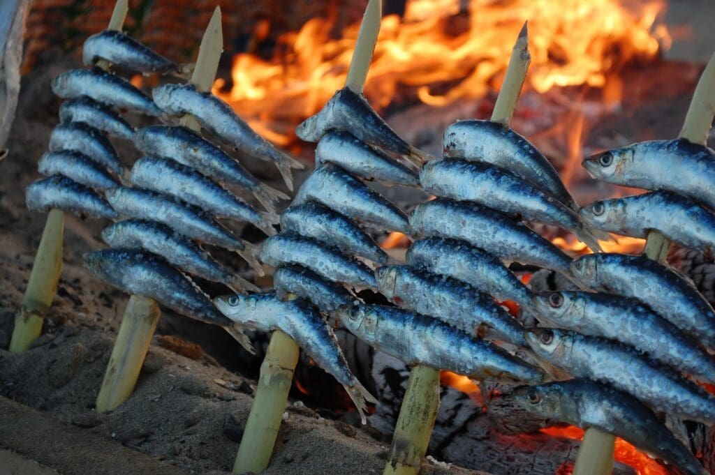 Freshly caught sardines roasted over an open fire.