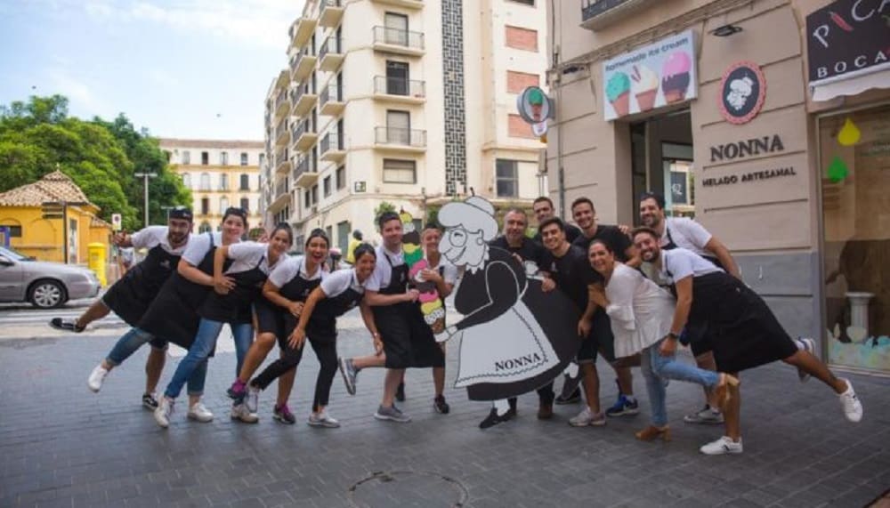 An image of the employees of Nonna ice cream place smiling in the front of the shop