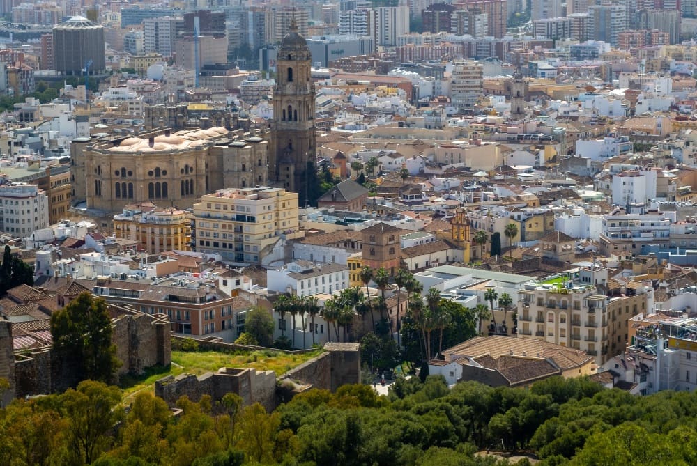 A scenic view of the lush green landscapes and rugged mountains of Northern Spain, under a cloudy sky, illustrating the region's natural beauty and diverse terrain