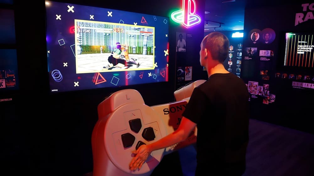 Person playing Tekken with a giant PlayStation at OXO - Museo del Videojuego in Malaga, Andalusia, Spain.