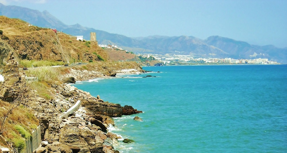 Panoramic view of Torrox coastline with mountains and lush greenery.