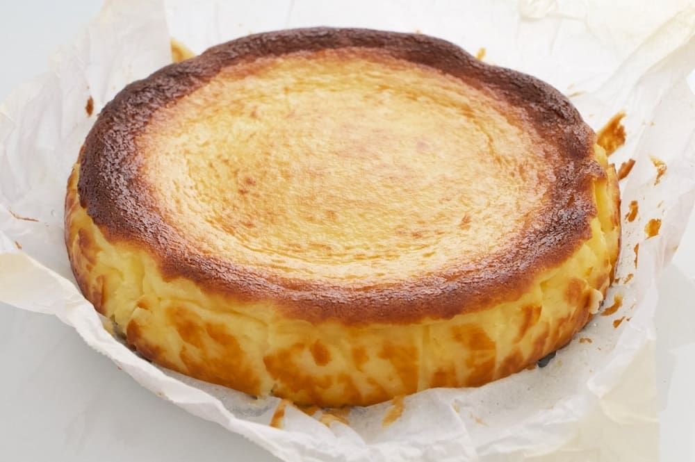 an image of the classic dessert from spain tarta de queso or cheese cake